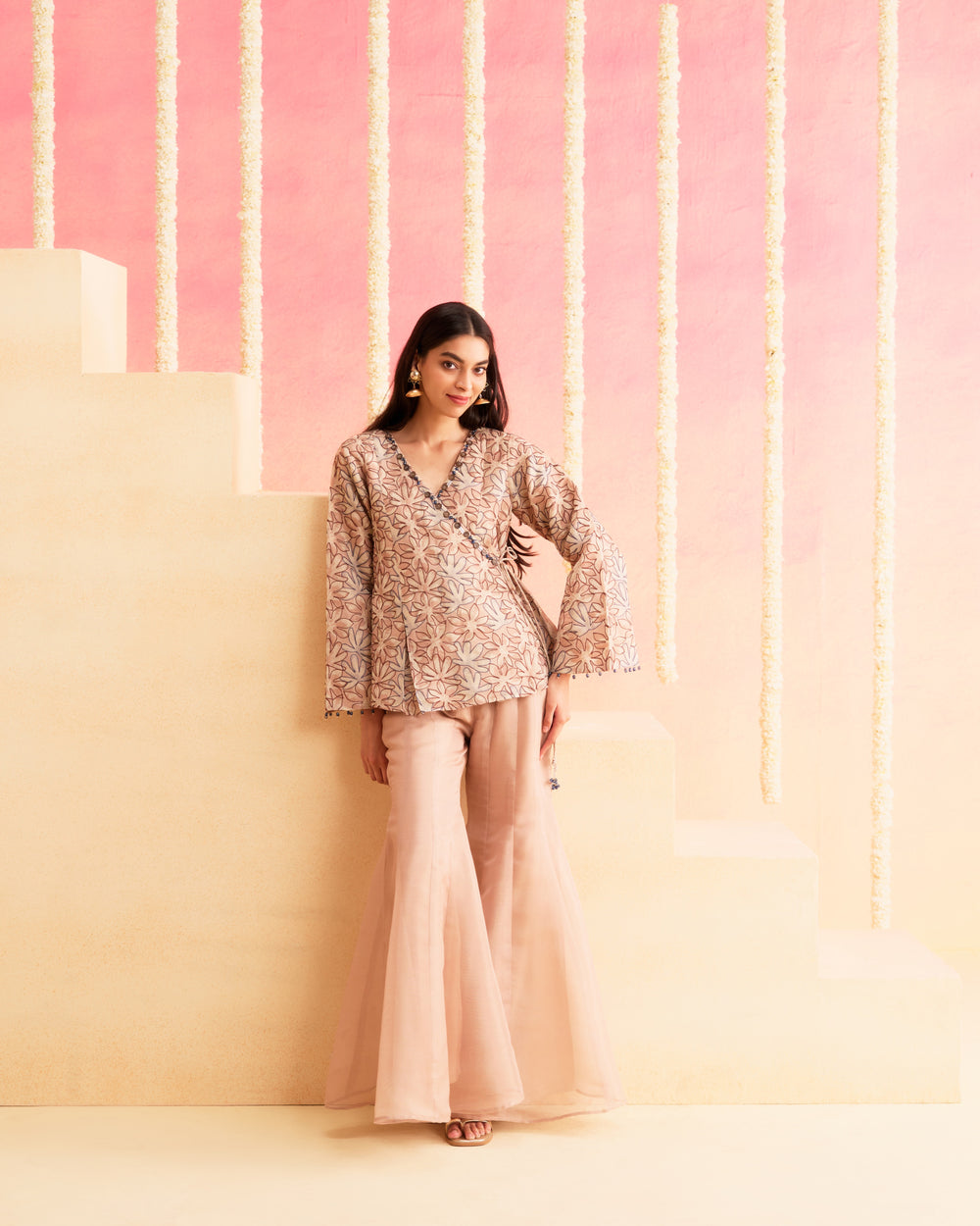 Sahar - A Soft Peach Wrap-Style Co-ord Set Featuring A Floral Patterned Top Paired With Flared Pants.