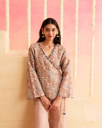 Sahar - A Soft Peach Wrap-Style Co-ord Set Featuring A Floral Patterned Top Paired With Flared Pants.