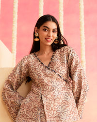 Sahar - A Soft Peach Wrap-Style Co-ord Set Featuring A Floral Patterned Top Paired With Flared Pants.